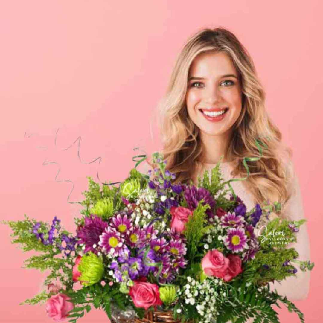 A young girl holding a A lavish flower arrangement, presented in a woven basket overflowing with fragrant blossoms, verdant foliage, and whimsical twigs. Salem Oregon flower delivery.